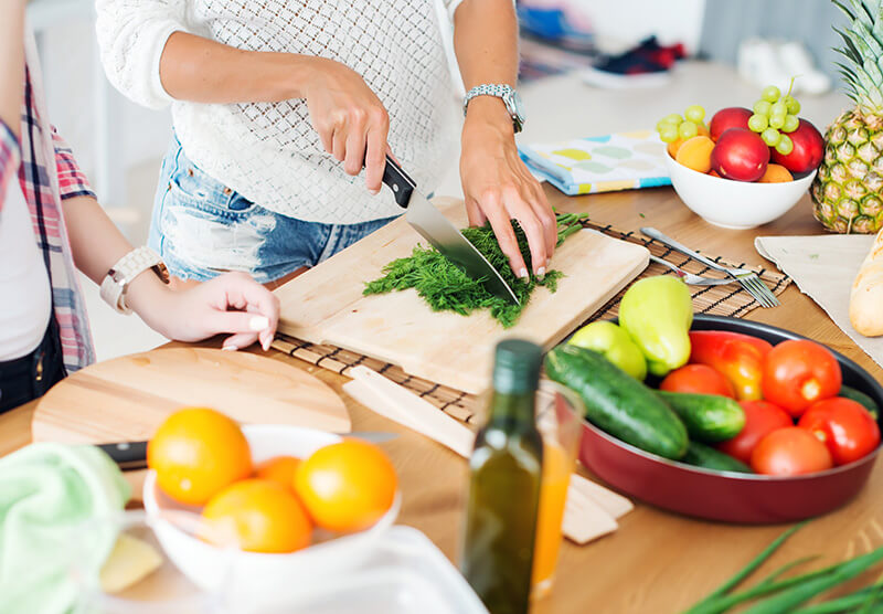 Gorgeous young Women preparing dinner in a kitchen